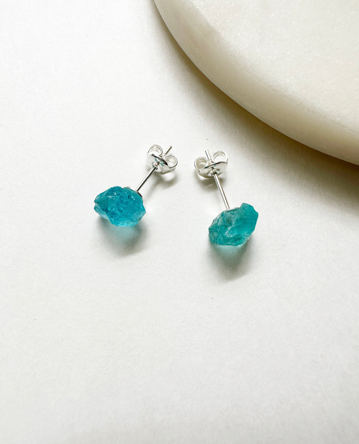 Raw aquamarine birthstone stud earrings with silver post.