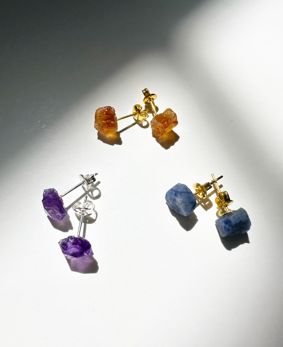 Photo of citrine, amethyst, and sapphire stud earrings.