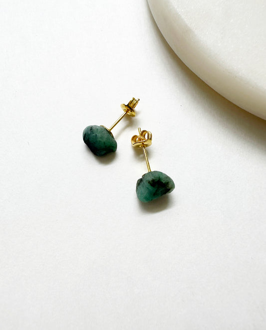 Raw emerald birthstone stud earrings with 14k gold post.