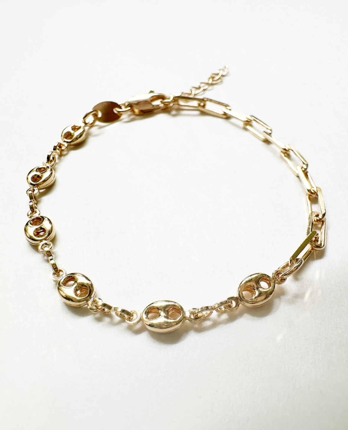 Close-up view of our Glow Bracelet featuring half paperclip chain and half mariner puff chain with a lobster closure.
