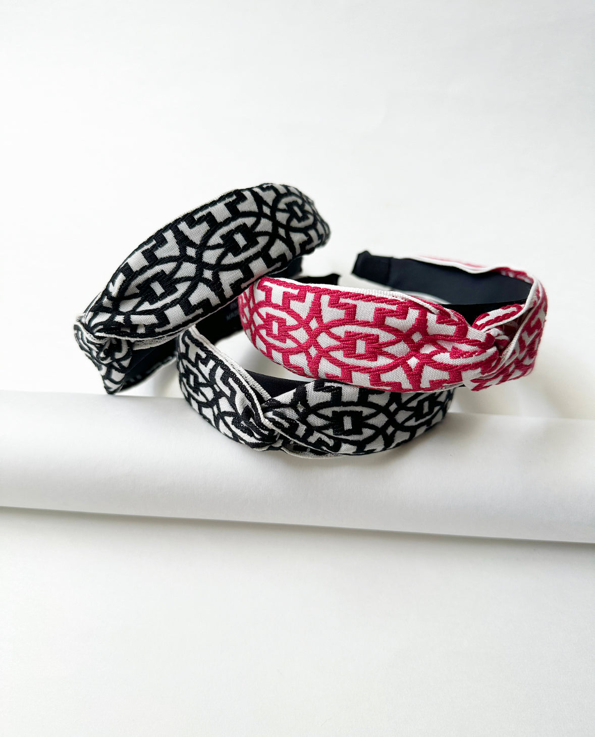 Photo of three That Girl Headbands (two in black/white and one in magenta/white).