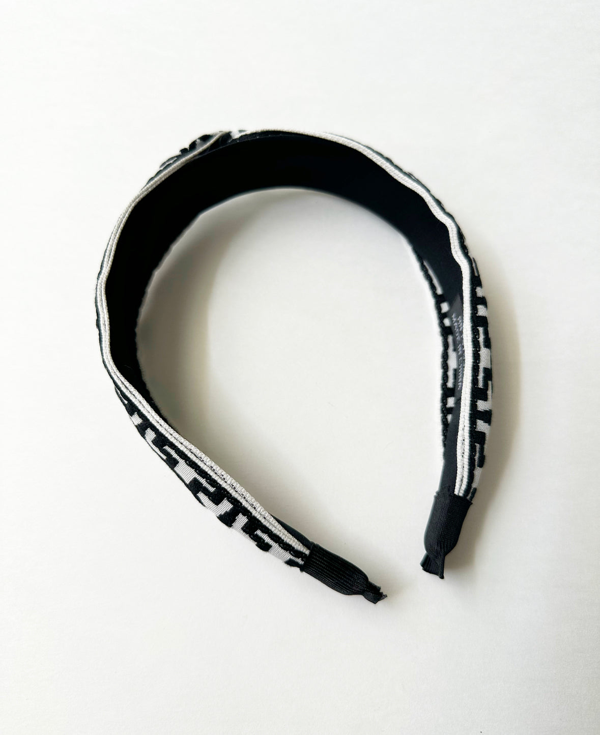 Photo showing inside of Black/White That Girl Headband and cloth-wrapped ends.