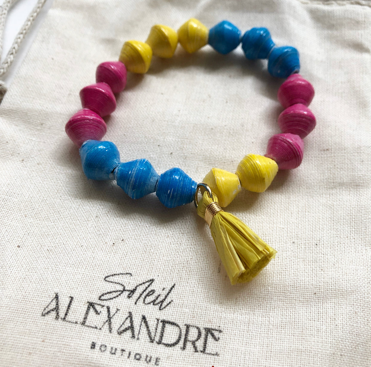 Candy Colored Beaded Bracelet styled on our drawstring jewelry bag.