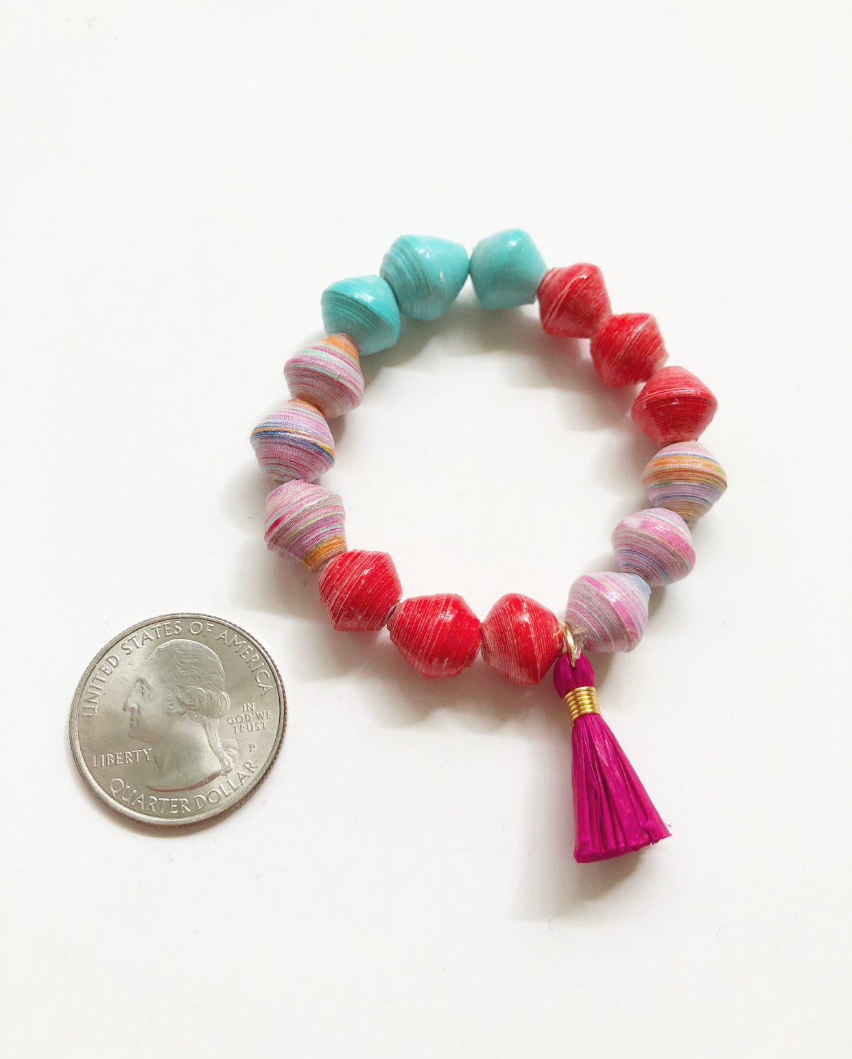 Unicorn Cotton Candy Bracelet next to a quarter for size comparison.