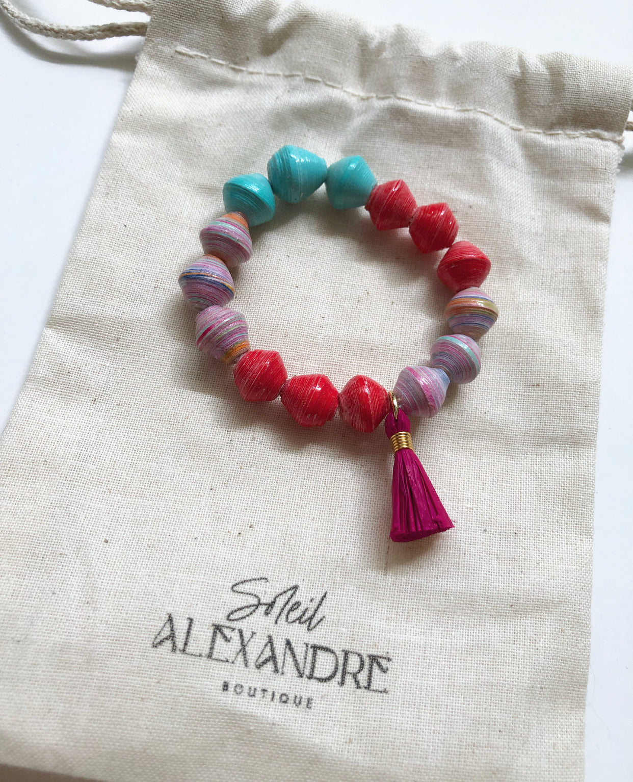 Unicorn Cotton Candy Beaded Bracelet styled on our drawstring jewelry bag.