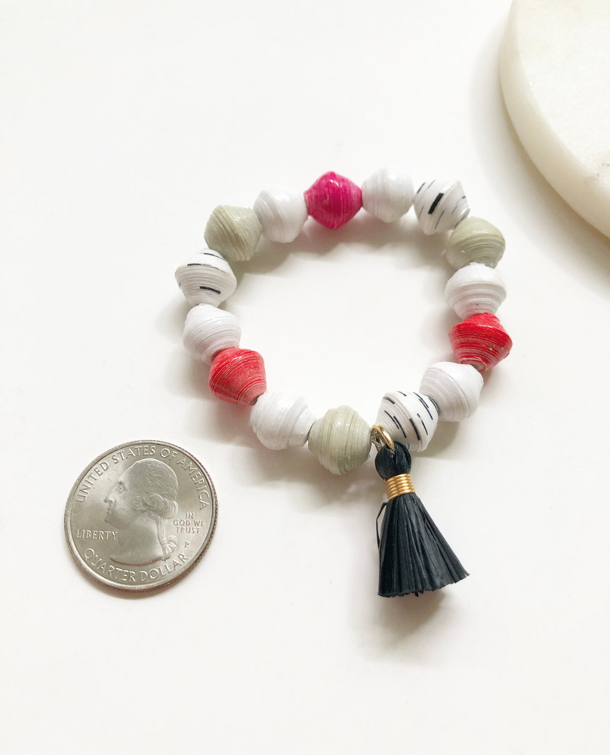 Strawberry Truffle Bracelet next to a quarter for size comparison.