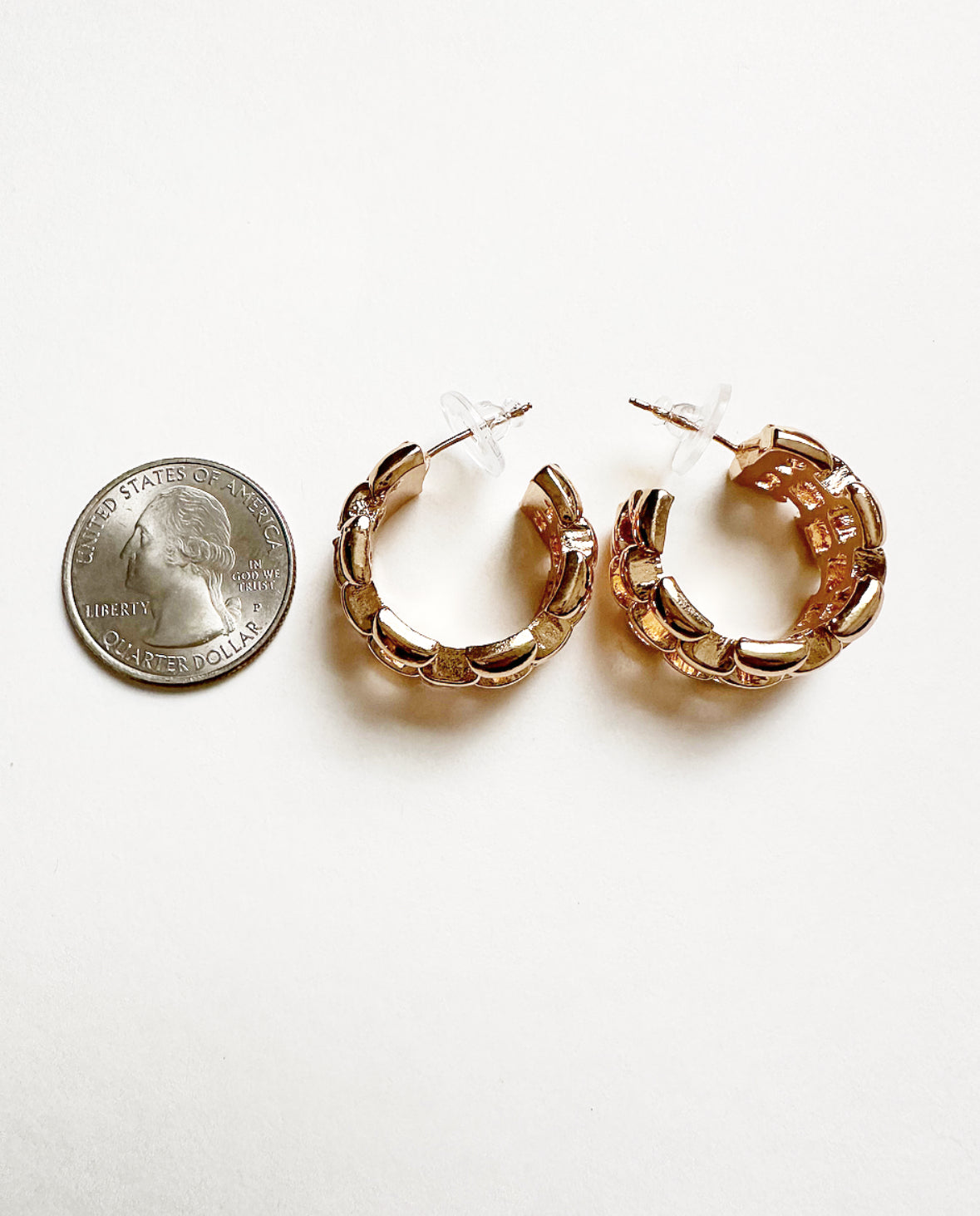 Betty Hoops next to a quarter for size comparison.