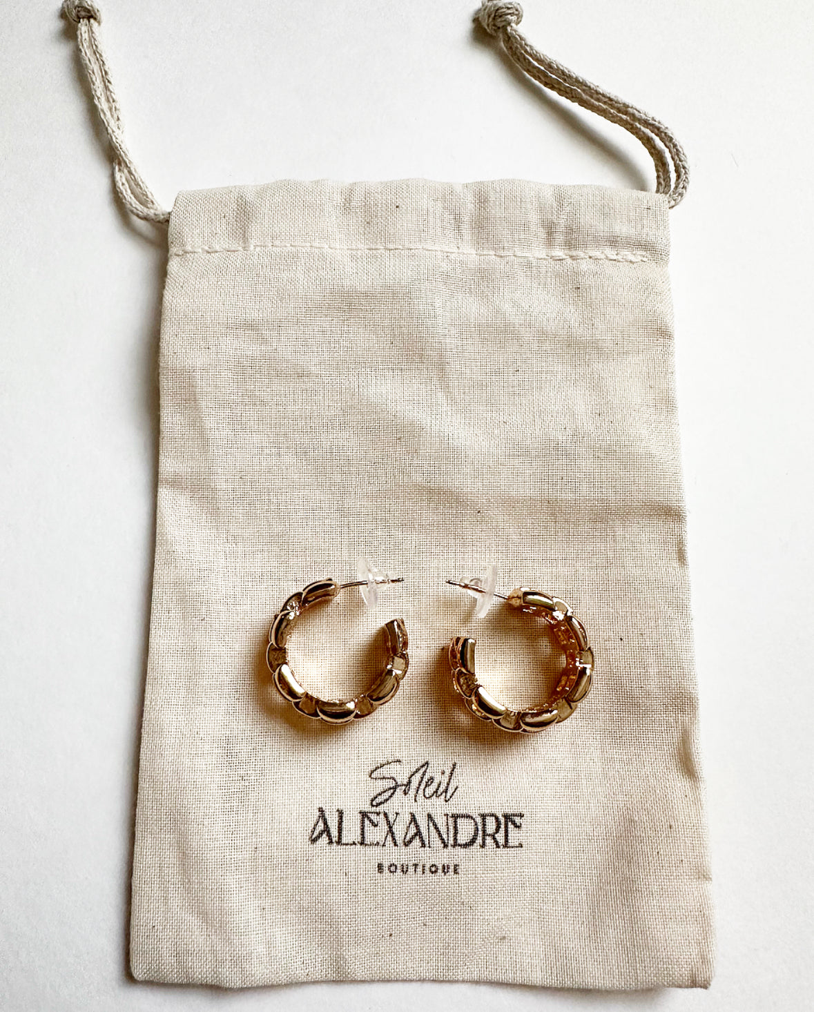Betty Hoops styled on our drawstring jewelry bag with logo.