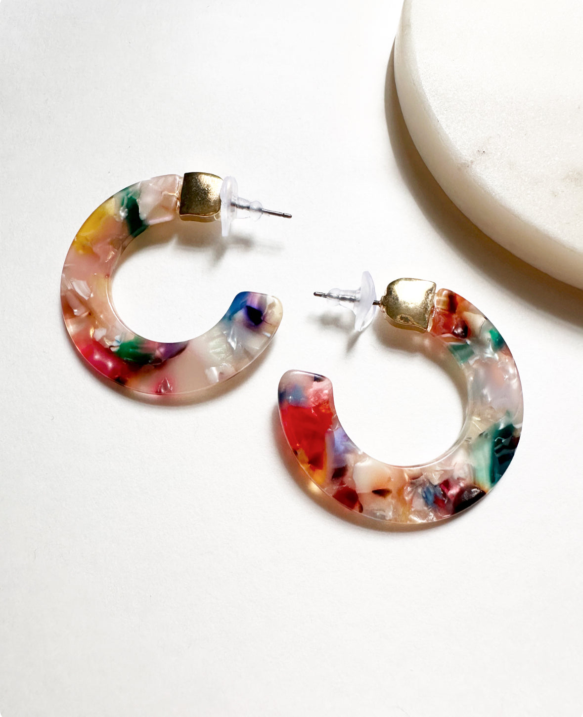 Full view of our Leilani Hoops in Tropicana Pink. Features dark blue, peach, pink, and white acrylic swirls with gold hardware.