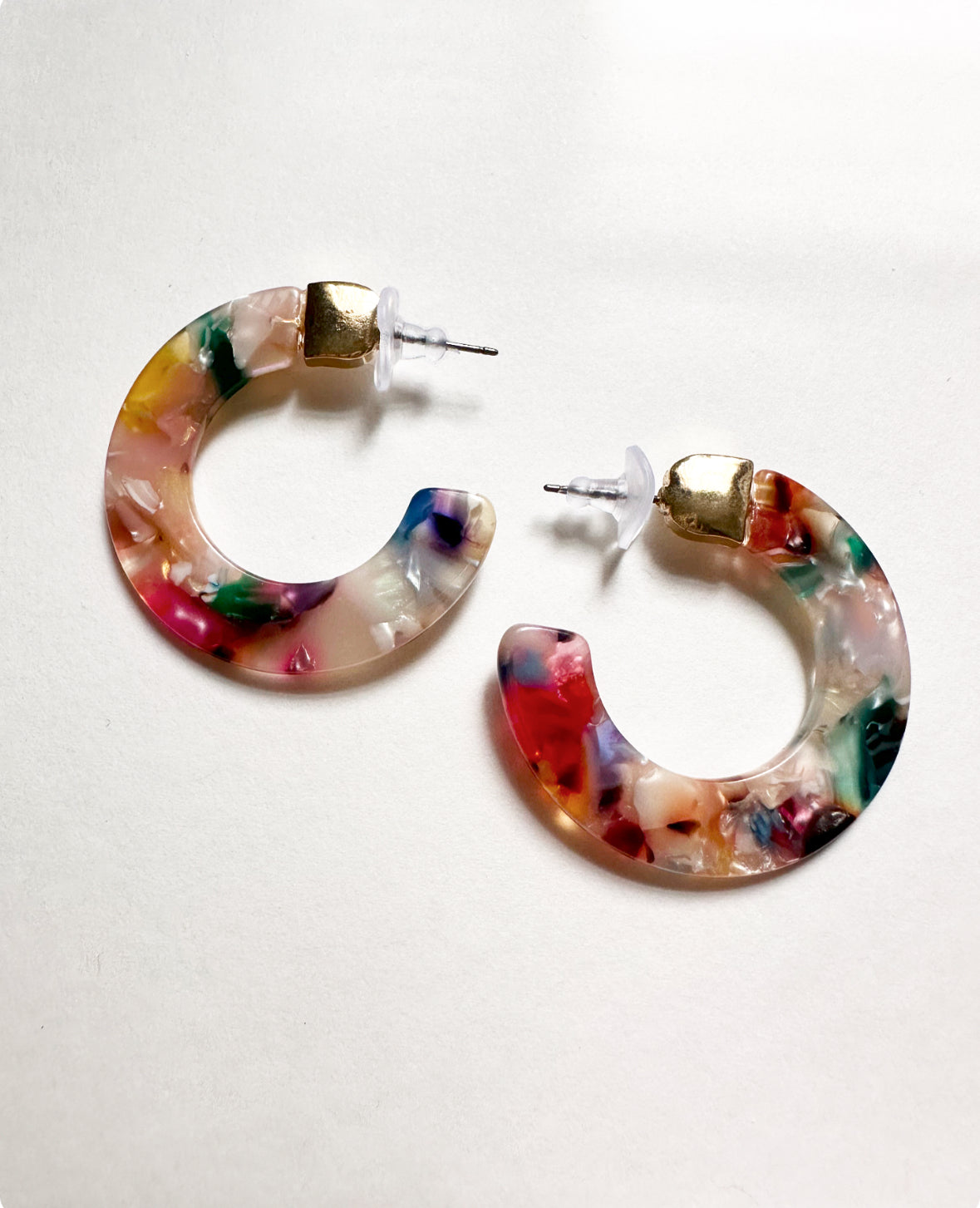 Alternate view of our Leilani Hoops in Tropicana Pink. Features dark blue, peach, pink, and white acrylic swirls with gold hardware.