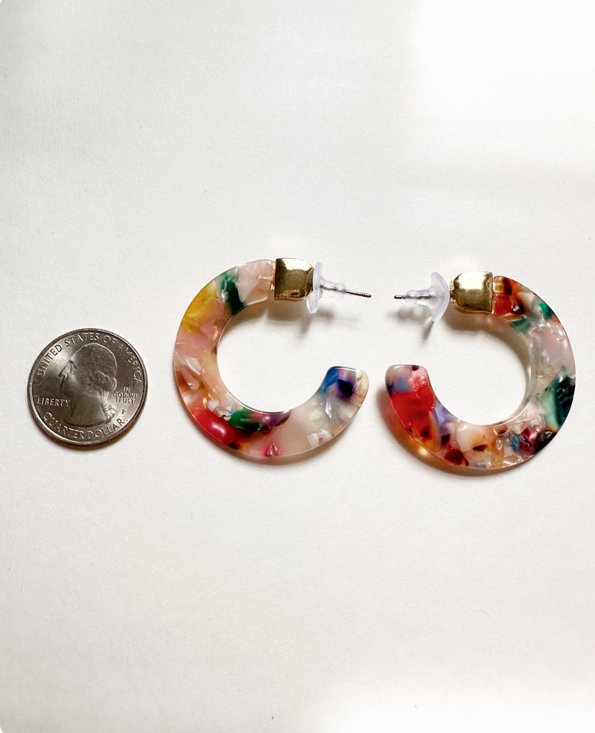 Tropicana Pink Leilani Hoops next to a quarter for size comparison.