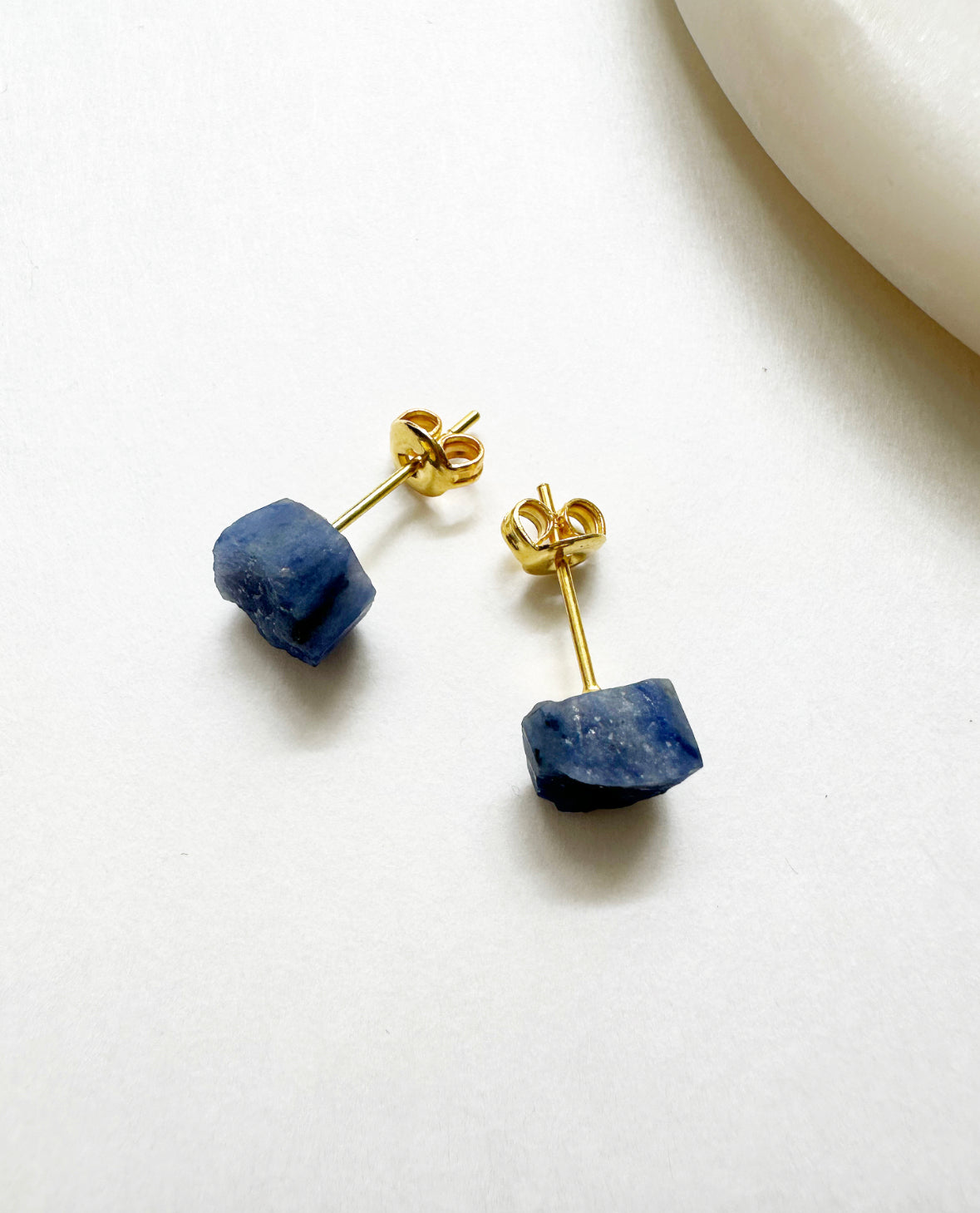 Raw sapphire birthstone stud earrings with 14k gold post.