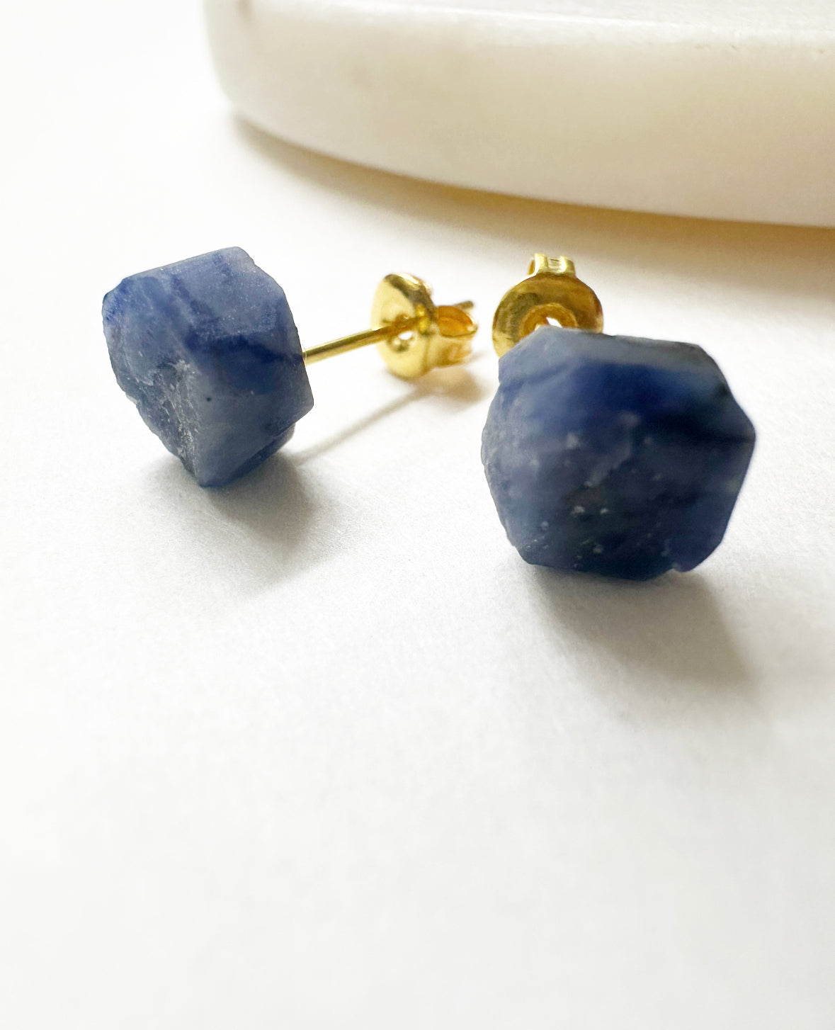 Close-up view of our raw sapphire stud earrings.