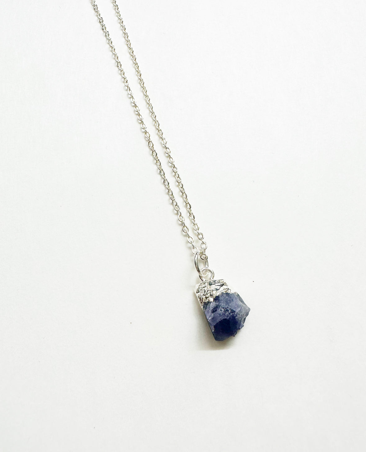 Photo of raw tanzanite birthstone necklace.