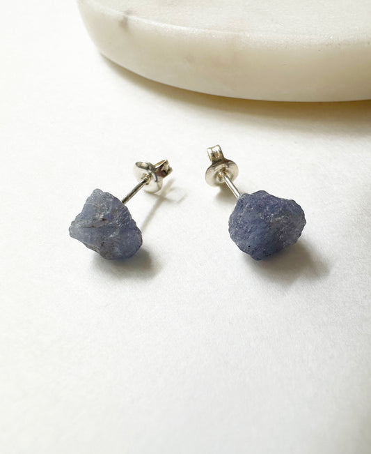 Close-up view of our raw tanzanite birthstone stud earrings.