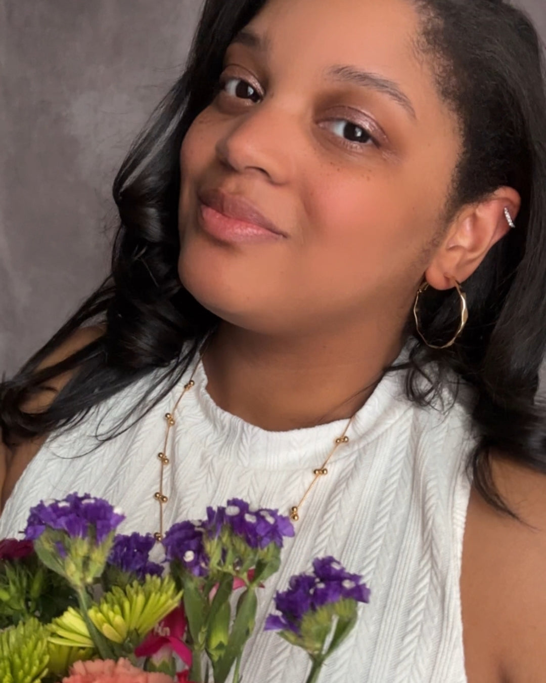 Vada Hoops modeled on earlobes with Harlow Huggies in cartilage.