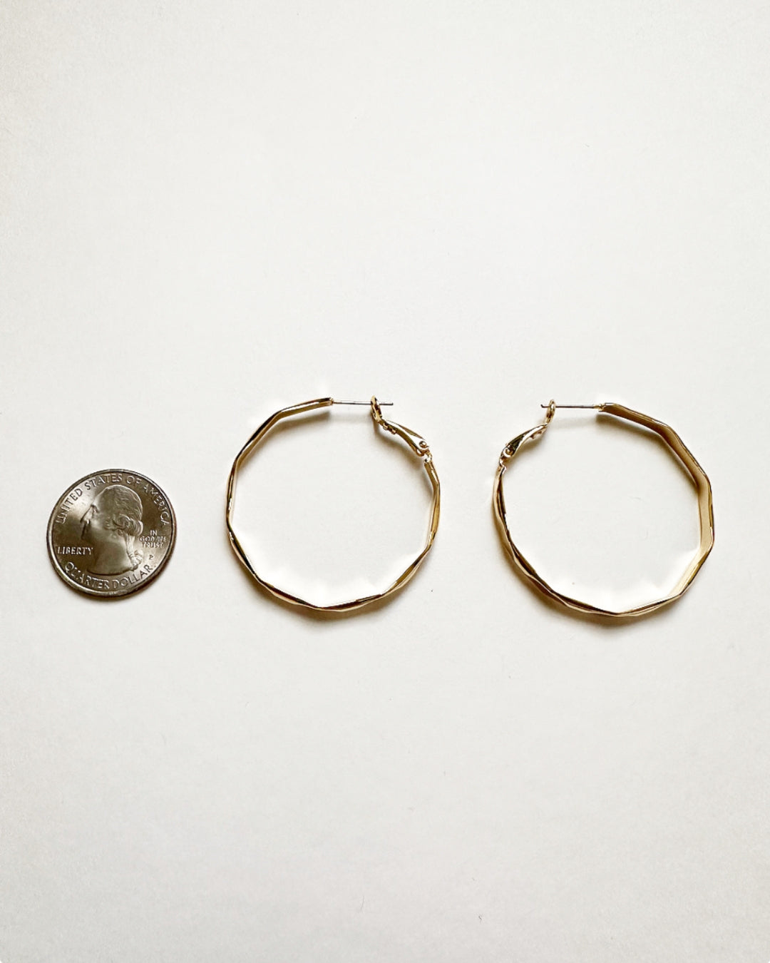 Vada Hoops shown next to a quarter for size comparison.