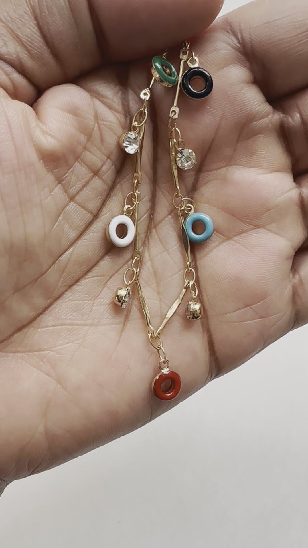 A real-time view of our Confection Choker Necklace shown on the palm of model's hand.