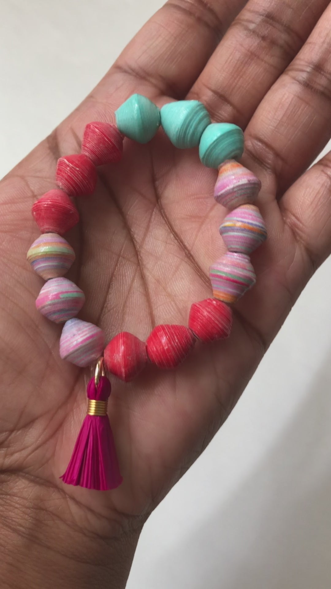 A real-time view of our Unicorn Cotton Candy Bracelet shown on the palm of our model’s hand.