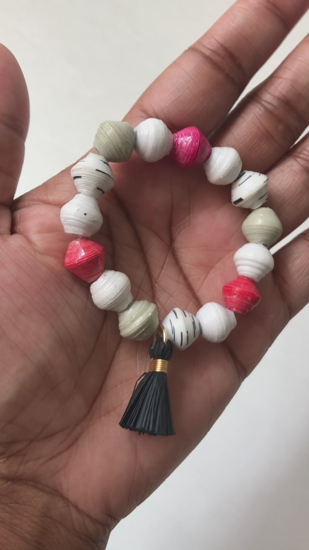 A real-time view of our Strawberry Truffle Bracelet shown on the palm of our model’s hand.