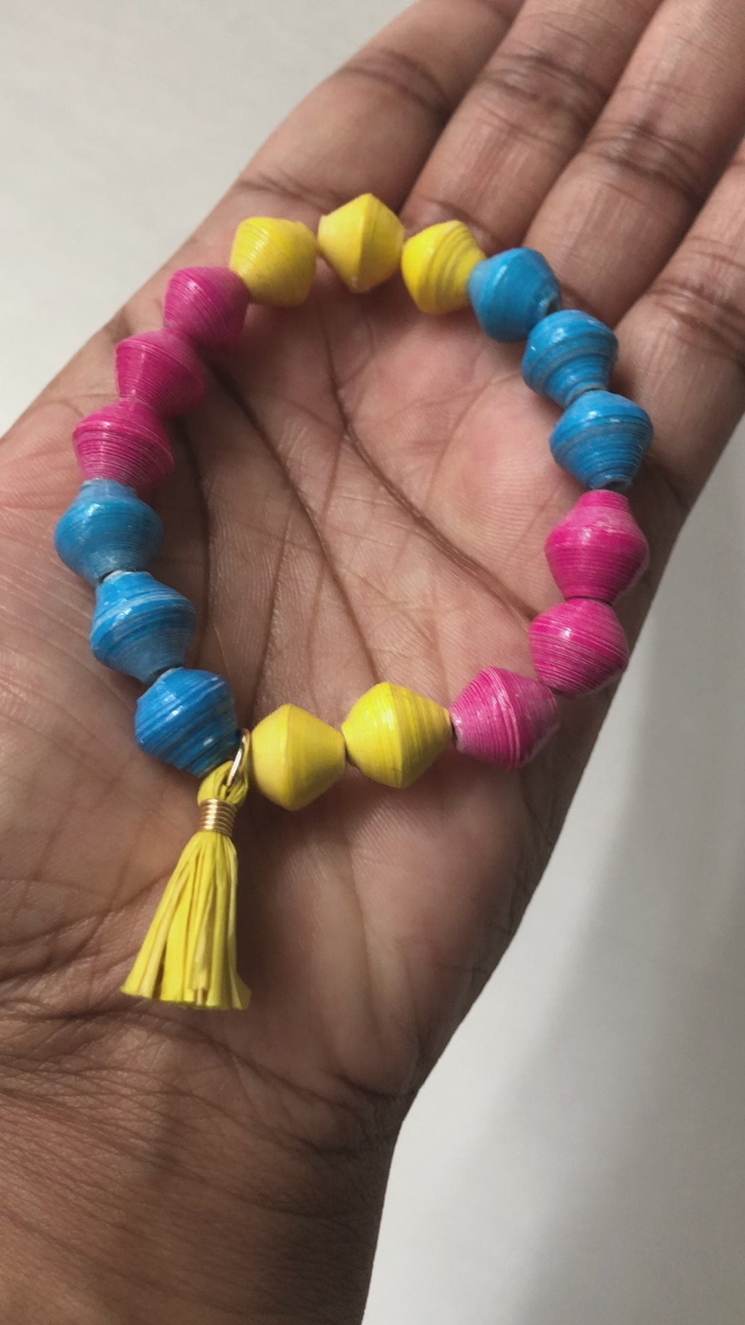 A real-time view of our Candy Colored Bracelet shown on the palm of our model’s hand.