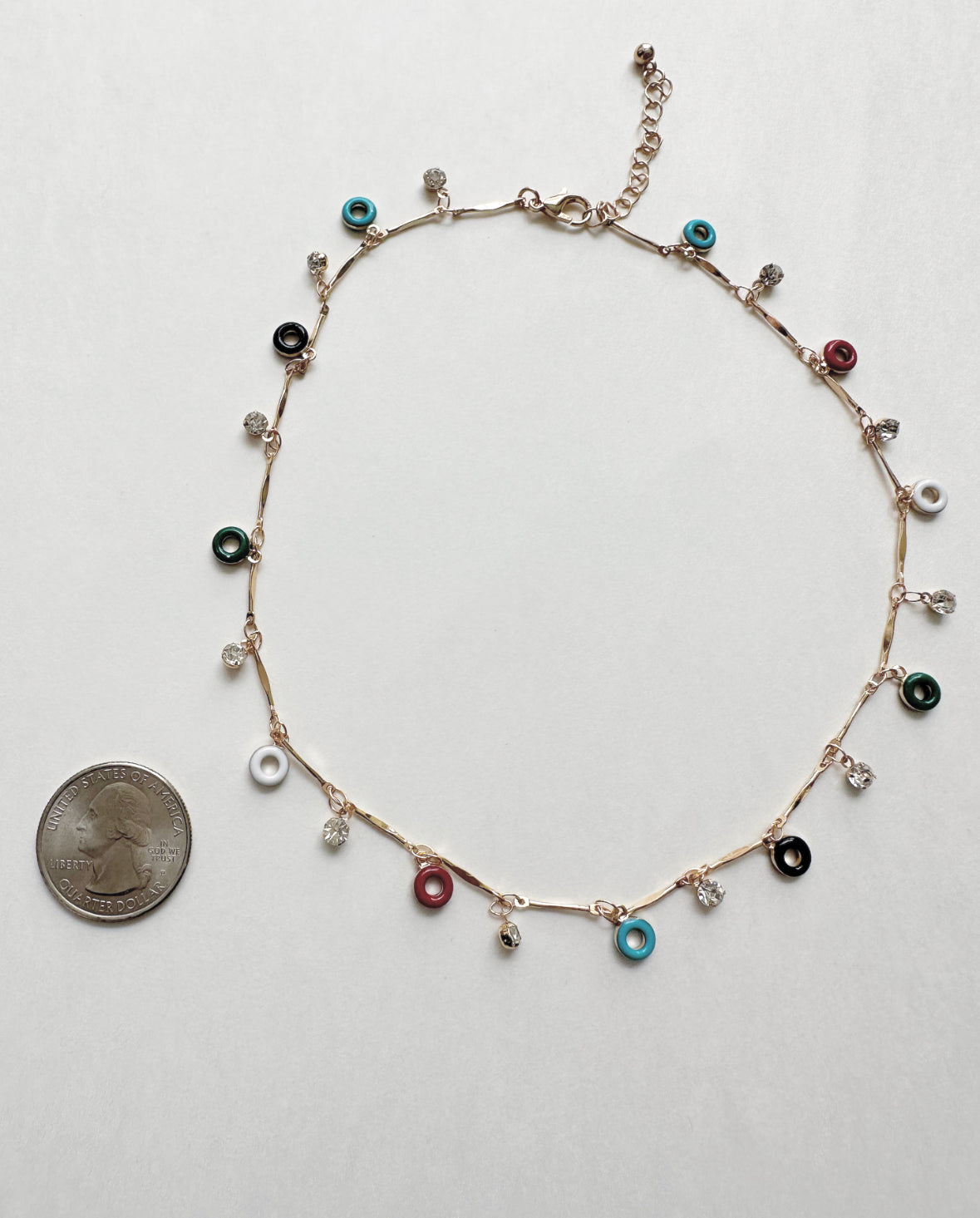 Confection Choker Necklace next to quarter for size comparison.