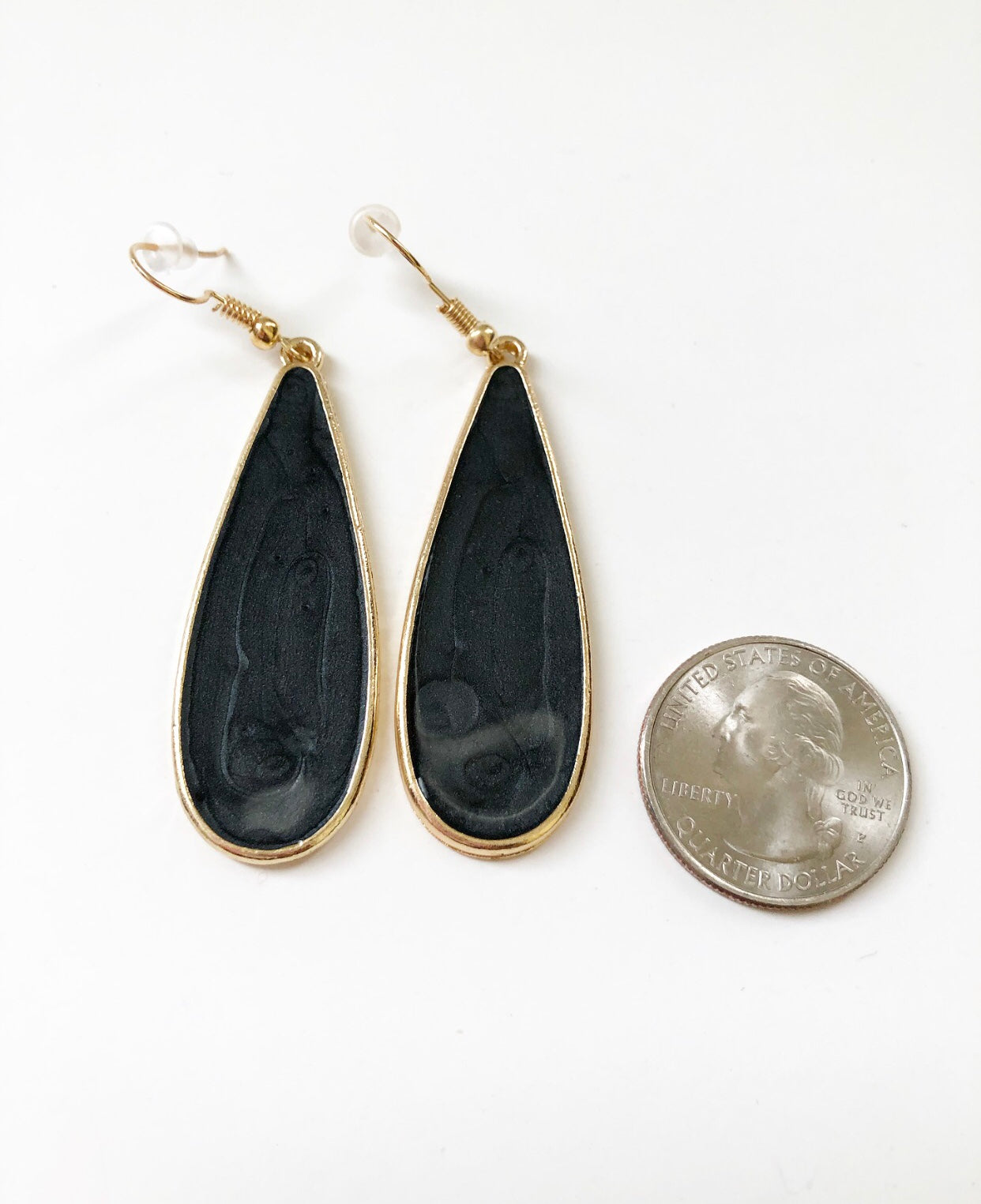 Black Candy Rain Drop Earrings next to a quarter for size comparison.