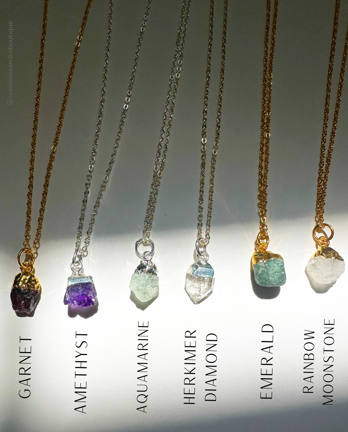 Photo of labeled January - June raw gemstone birthstone necklaces.