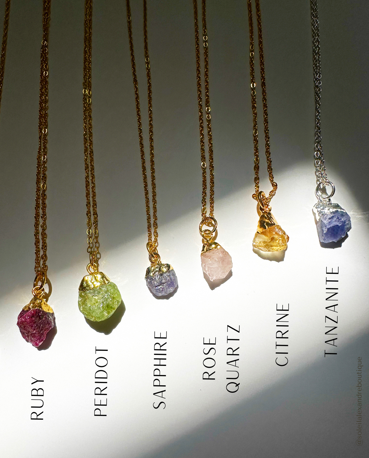 Photo of labeled July - December raw gemstone birthstone necklaces.