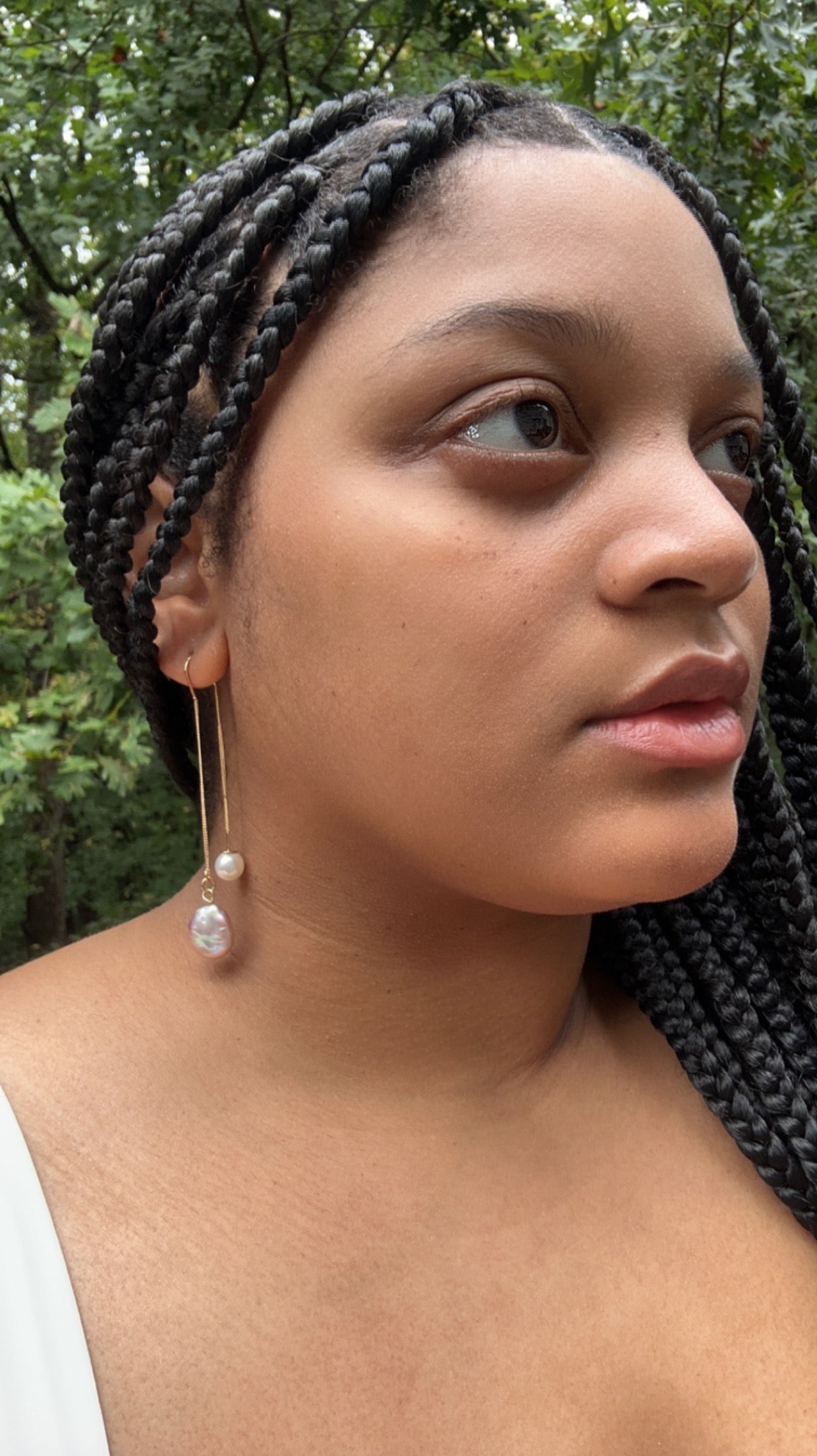 Closer view of model shown wearing Adorn Earrings.