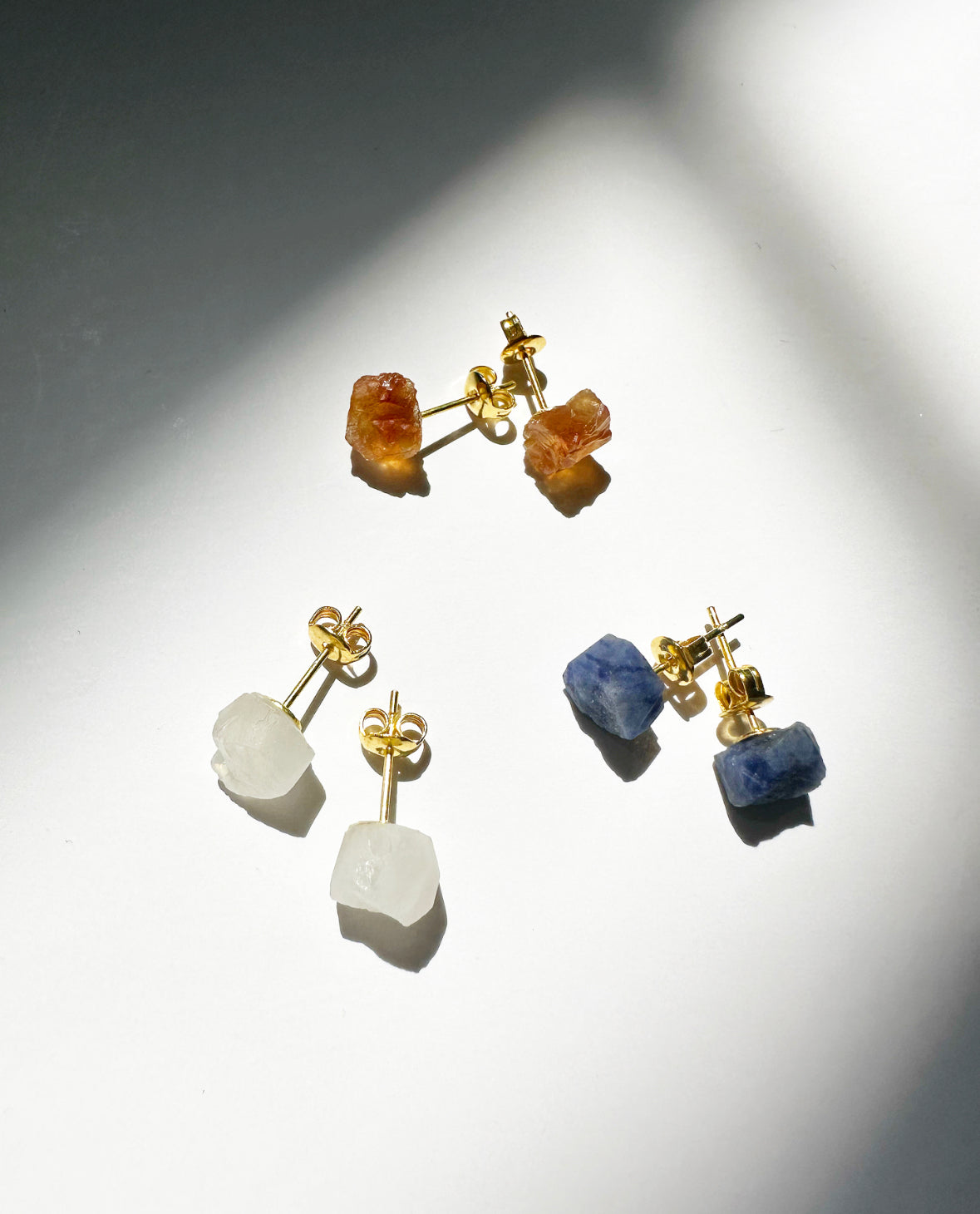 Photo of citrine, rainbow moonstone, and sapphire stud earrings.