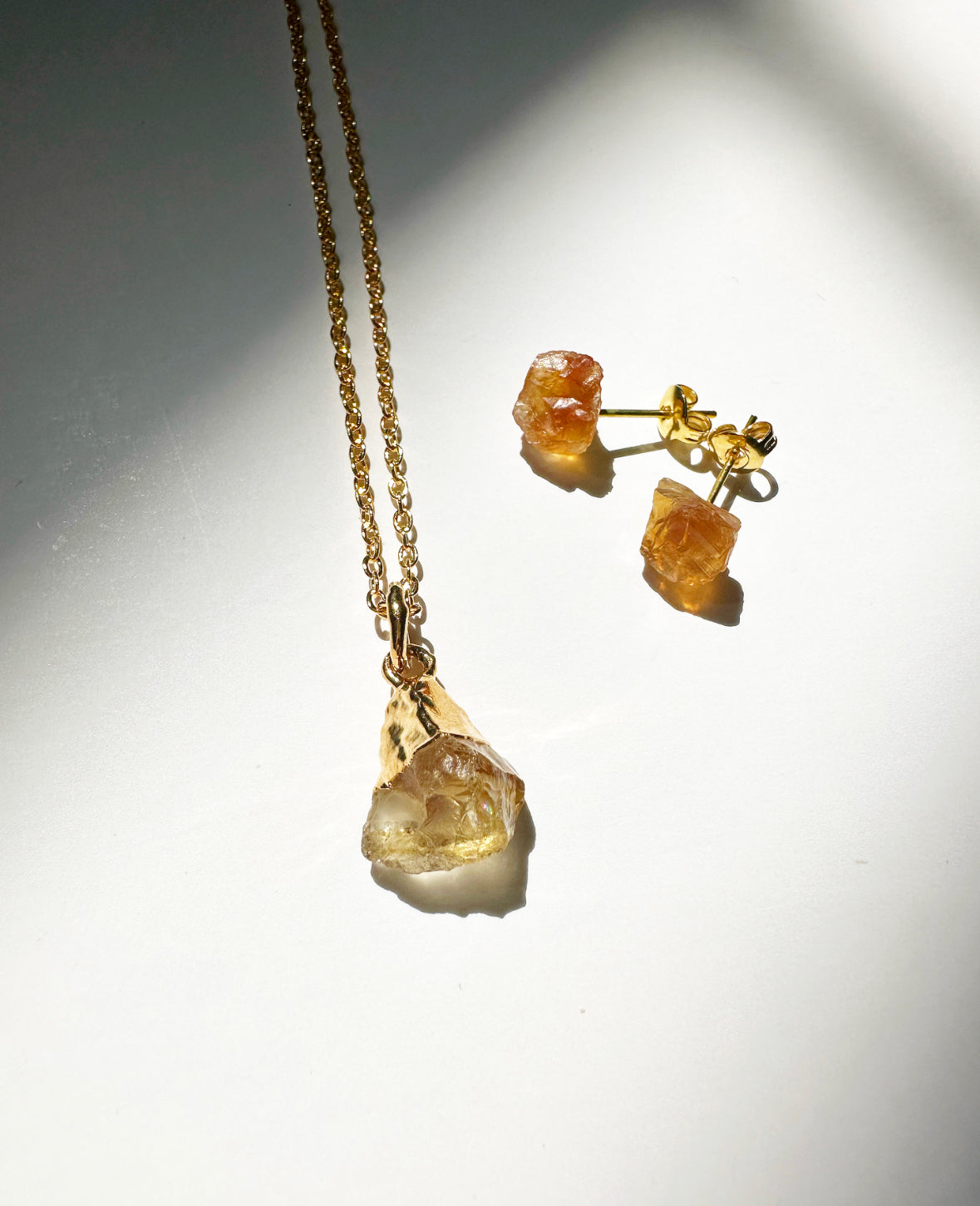 Photo of raw citrine birthstone necklace and matching raw citrine birthstone stud earrings.