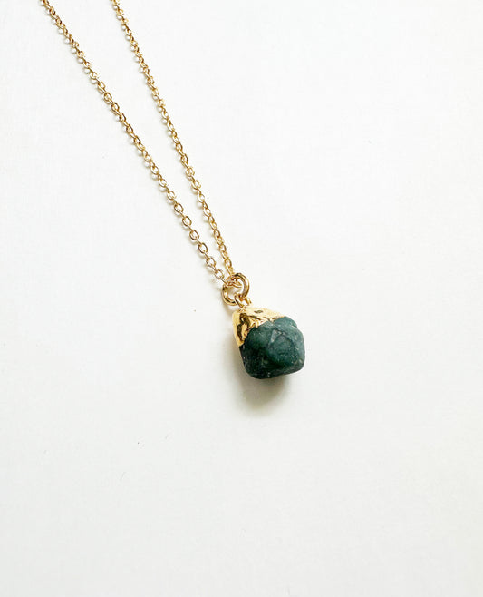 Photo of raw emerald birthstone necklace.