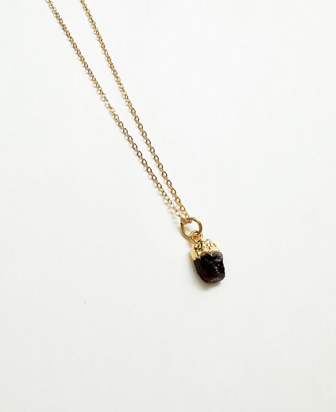 Photo of raw garnet birthstone necklace.