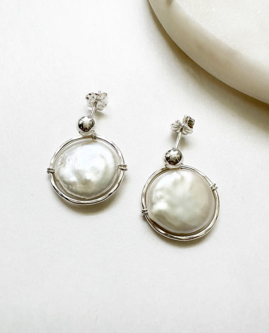 Front view of our Halo Earrings featuring freshwater coin pearls surrounded by a halo of sterling silver.