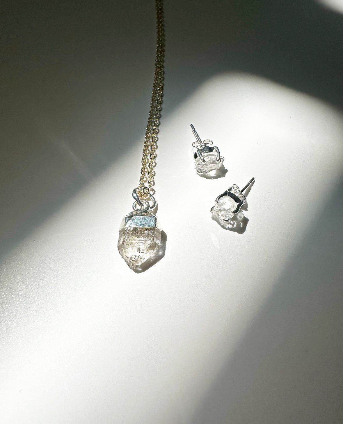 Photo of raw Herkimer diamond birthstone necklace and matching raw Herkimer diamond birthstone stud earrings.