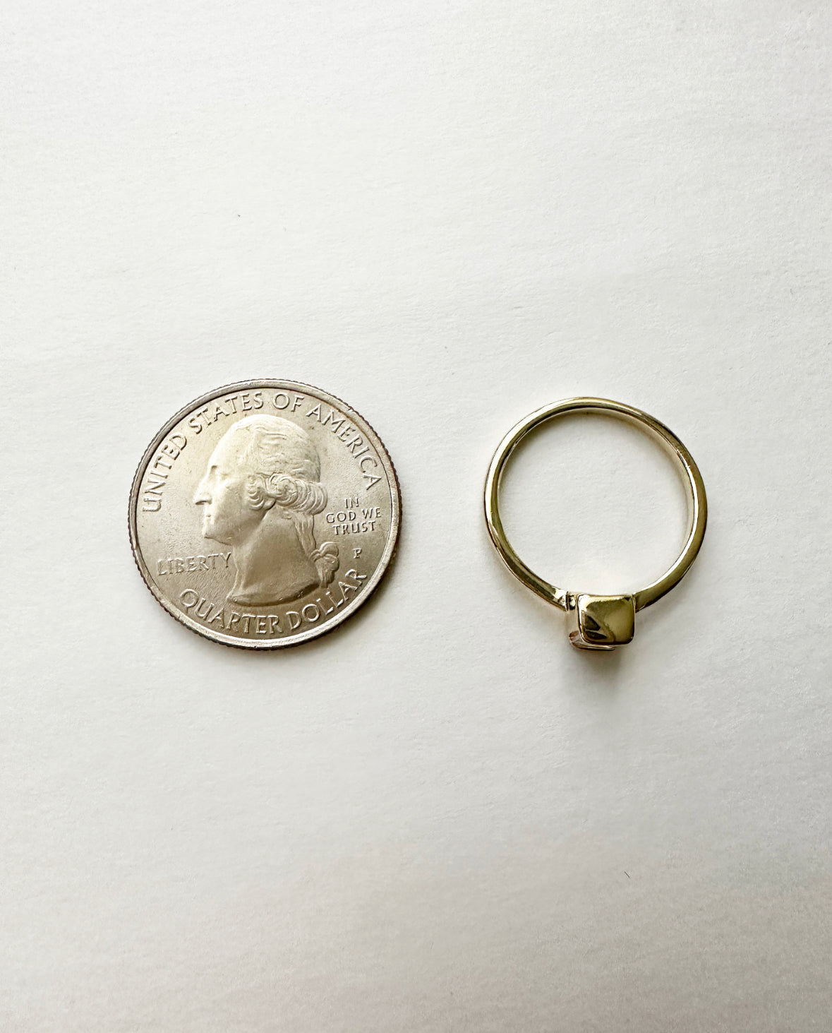 Angel of Mine Ring next to a quarter for size comparison.