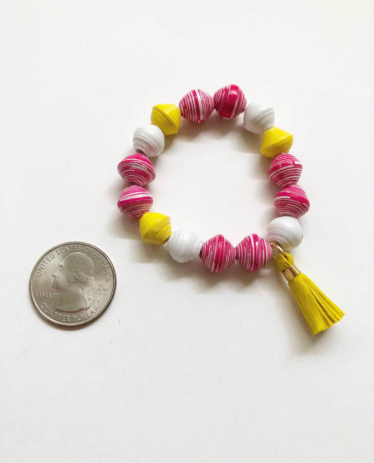 Iced Strawberry Lemonade Bracelet next to a quarter for size comparison.