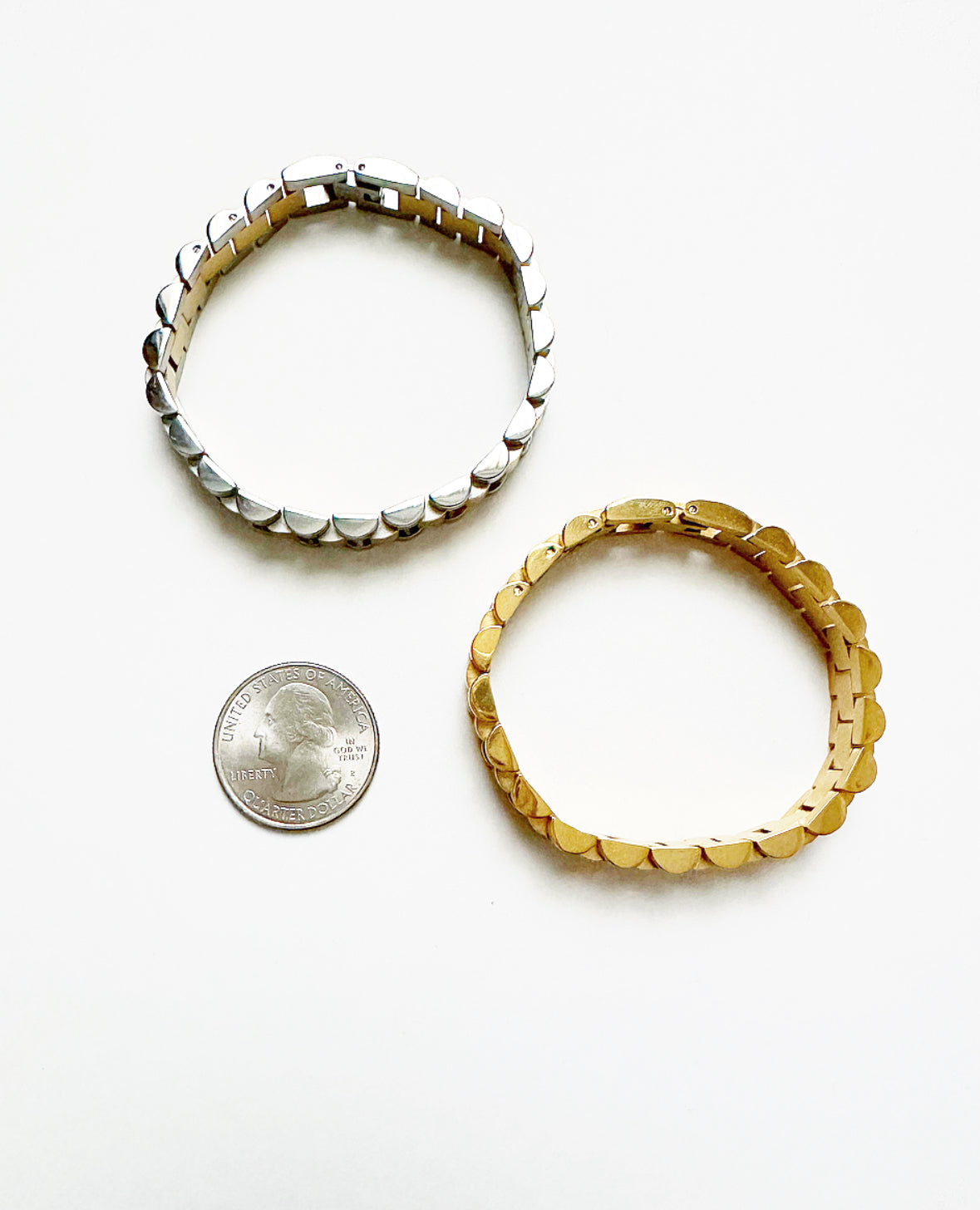 B+B Bracelets shown next to a quarter for size comparison.