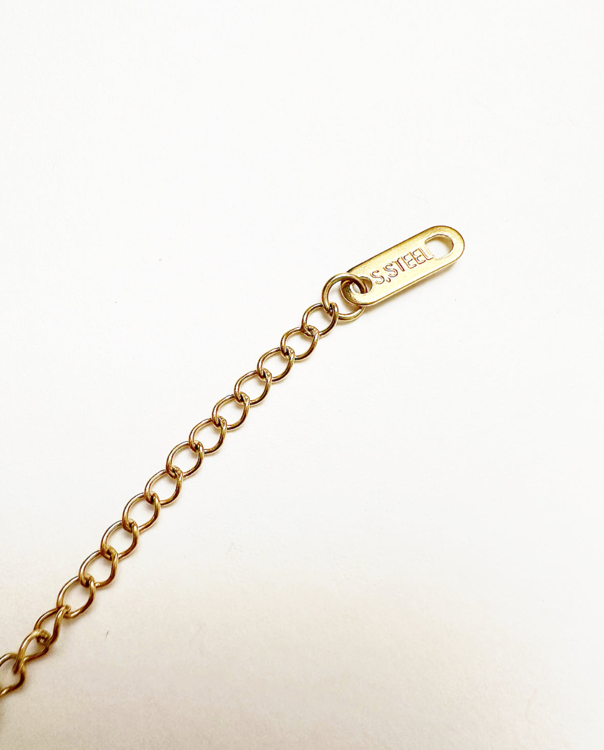 Stainless Steel tag at the end of the 2-inch extender on our Billie Chain Necklace.