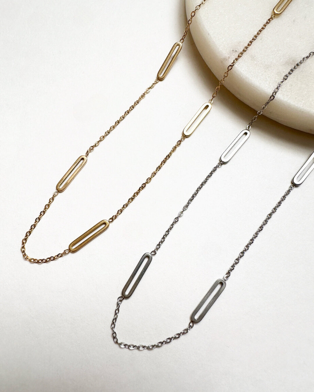 Our gold and silver Paloma Necklaces featuring  a trace chain intermixed with paperclip chain links.