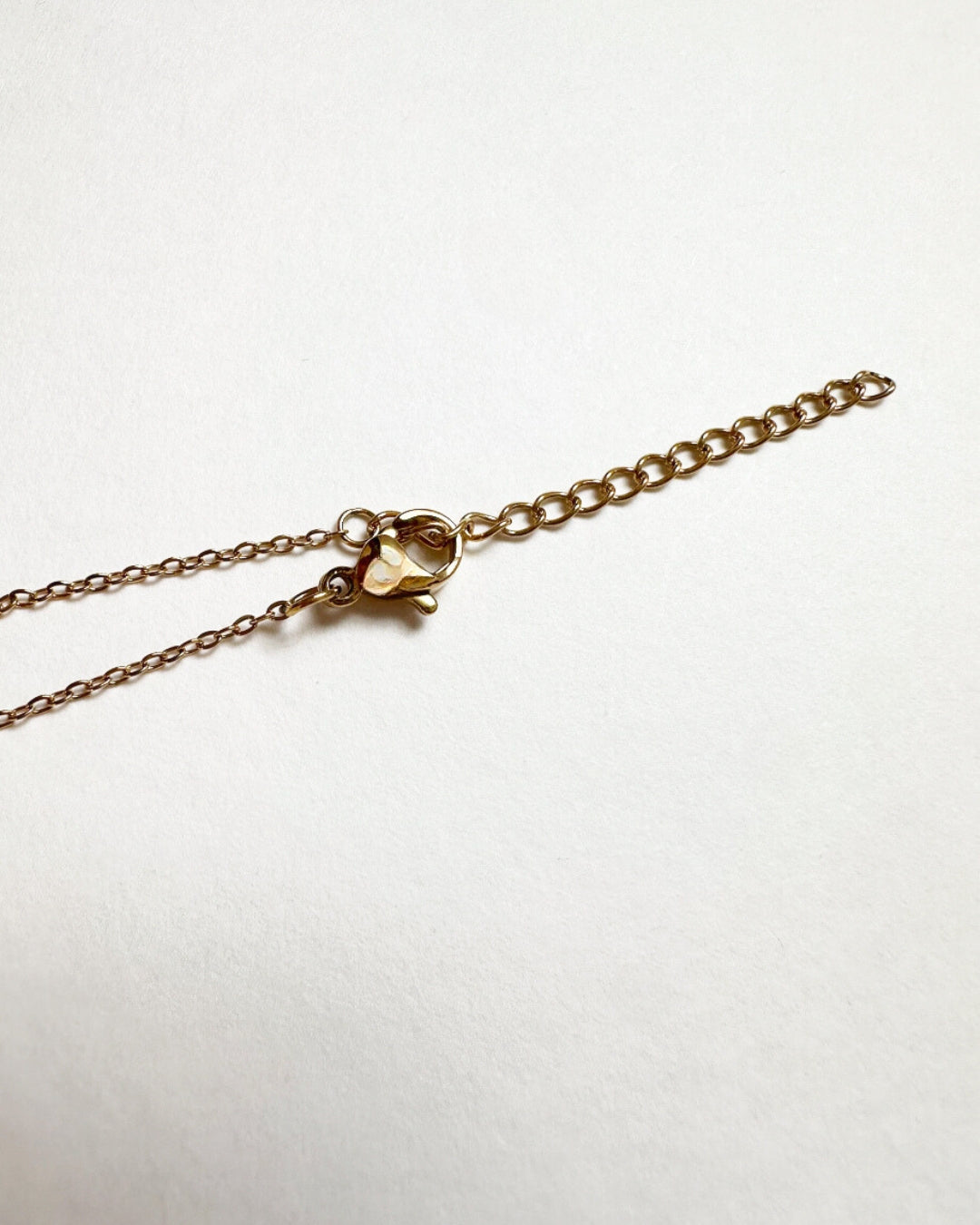 Close-up view of lobster clasp and extended chain on Paloma Necklace.