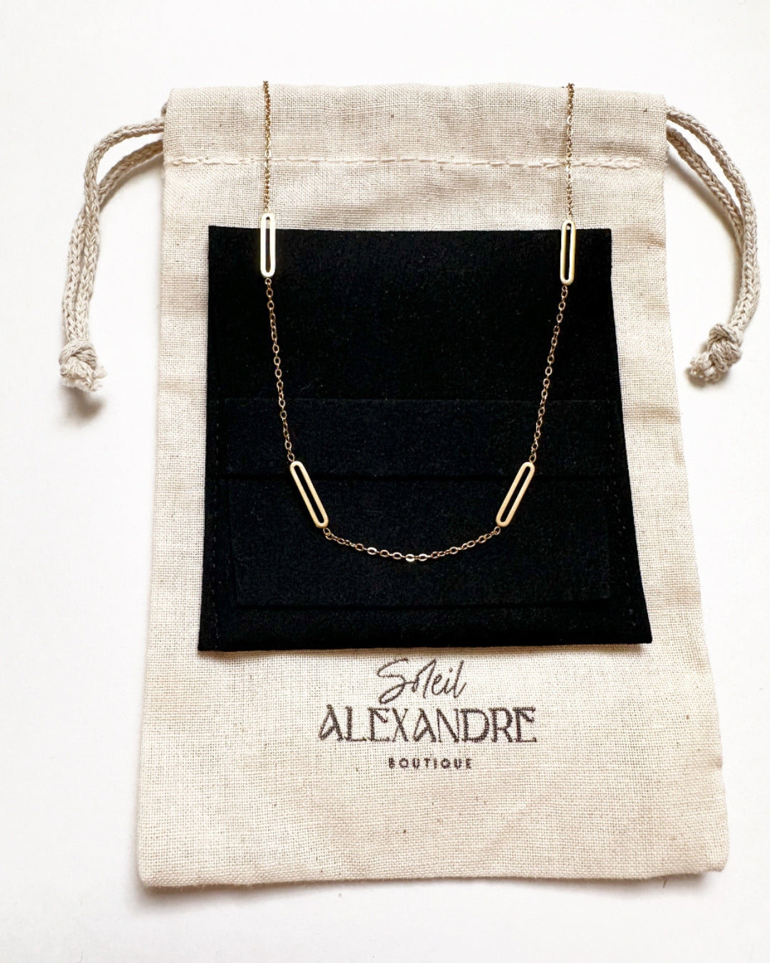 Gold Paloma Necklace shown styled on our drawstring jewelry bag.