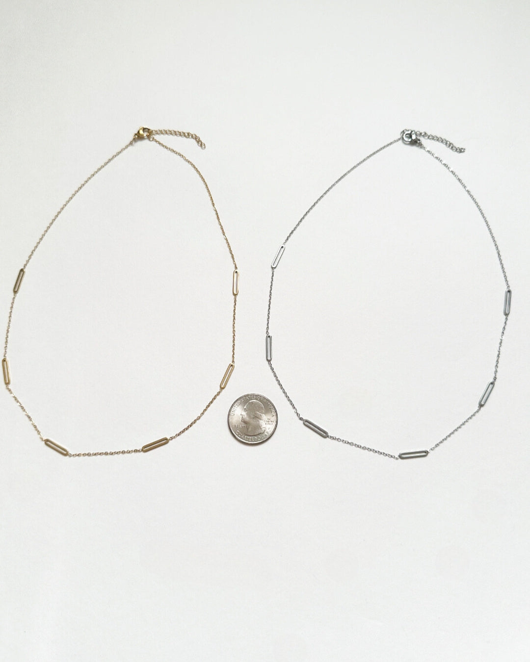 Gold Paloma Necklace and silver Paloma Necklace shown next to a quarter for size comparison.