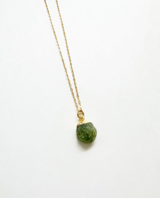 Photo of raw peridot birthstone necklace.