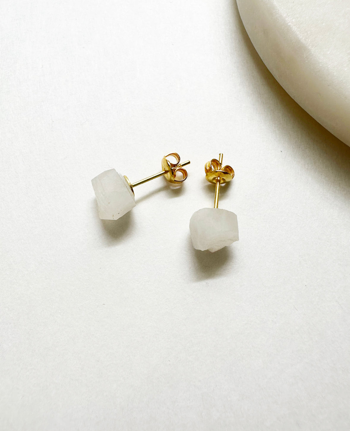 Raw rainbow moonstone birthstone stud earrings with 14k gold post.