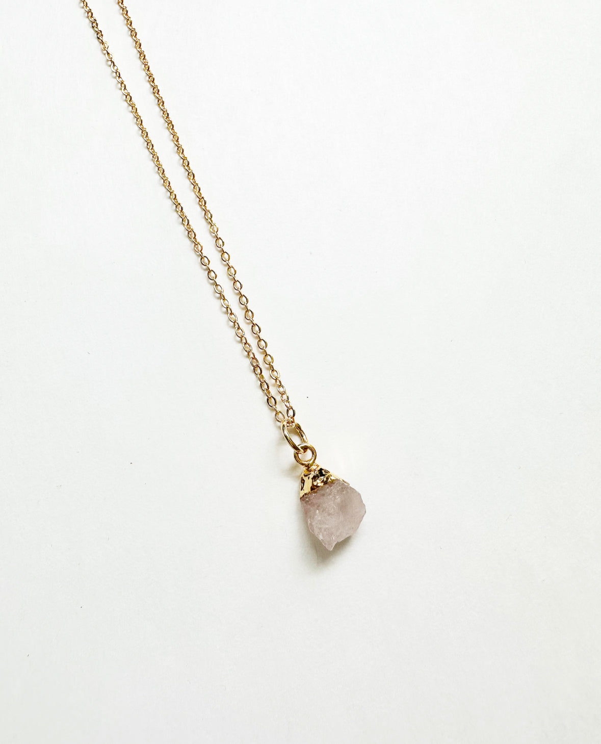 Photo of raw rose quartz birthstone necklace.