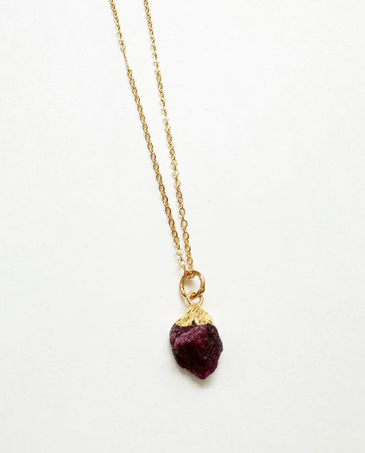 Photo of raw ruby birthstone necklace.