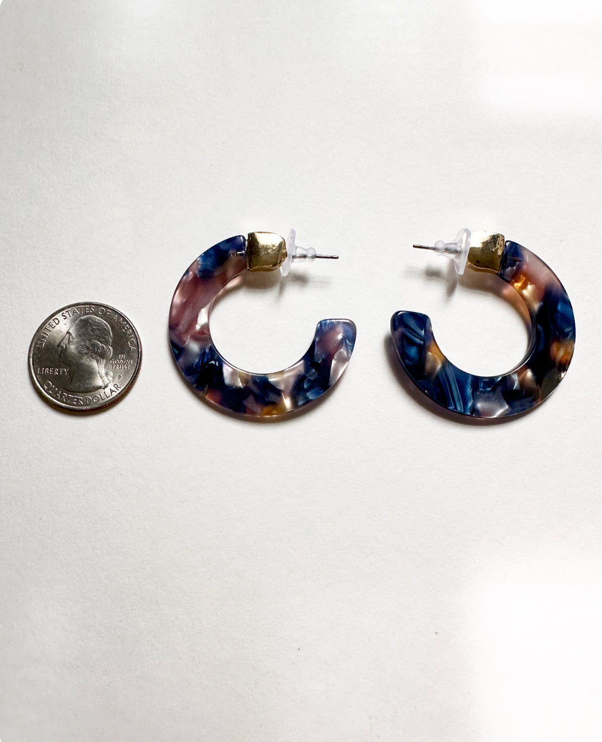 Oceanic Blue Leilani Hoops next to a quarter for size comparison.