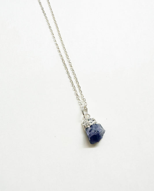 Photo of raw tanzanite birthstone necklace.